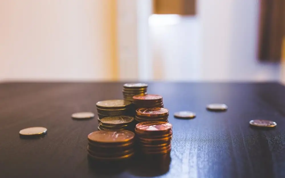 Small stacks of coins on a dark wooden table